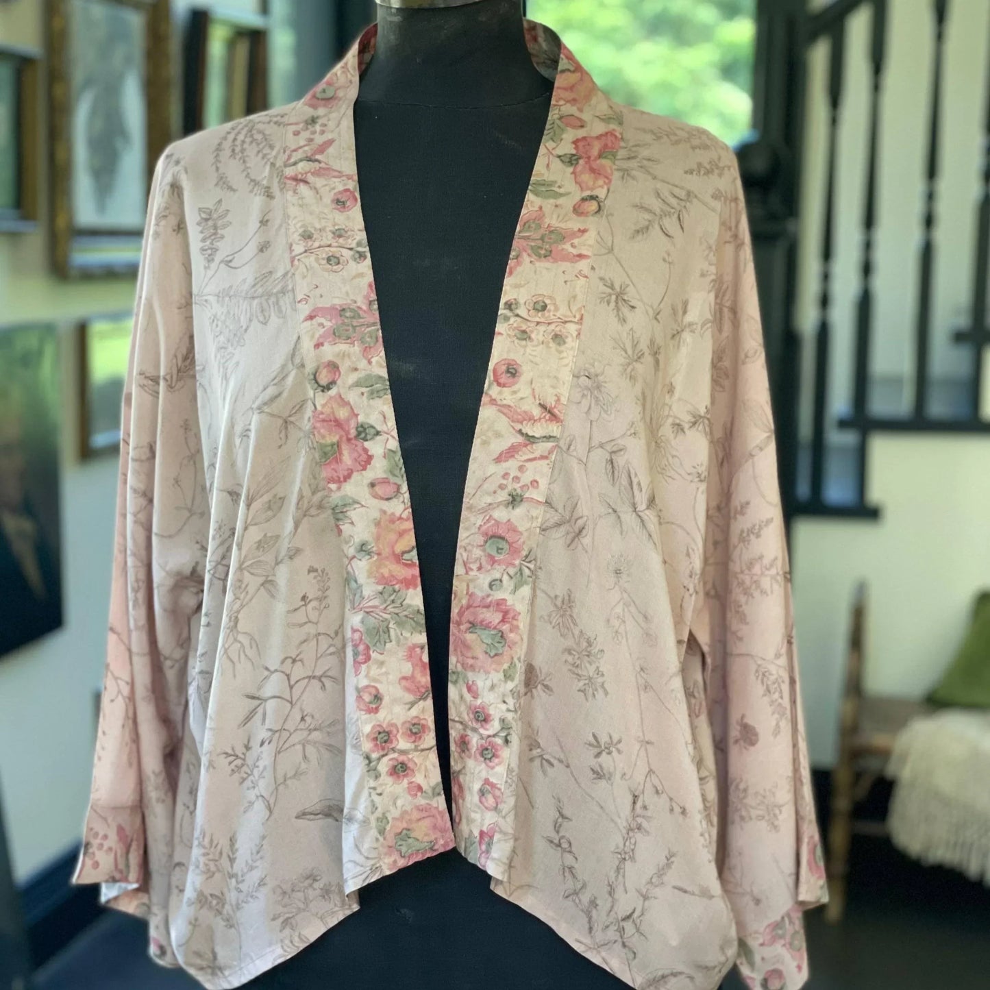 Delicate floral kimono with soft pink and green botanical print, perfect for gifting or home décor.