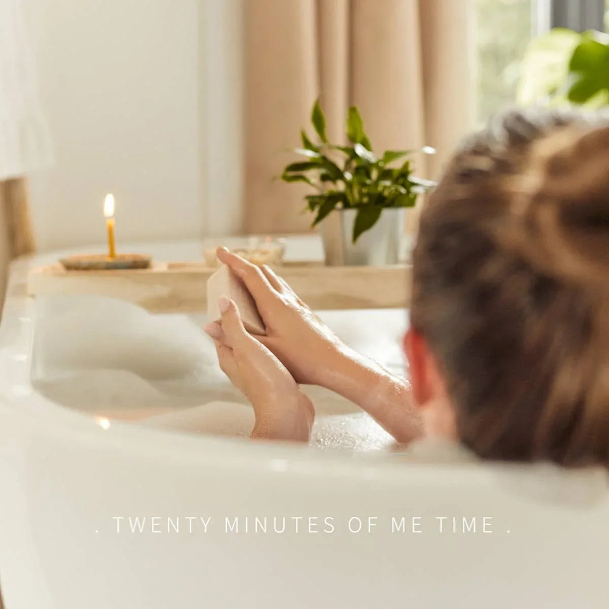 Relaxing bath with candle and greenery, perfect for self-care and me time moments