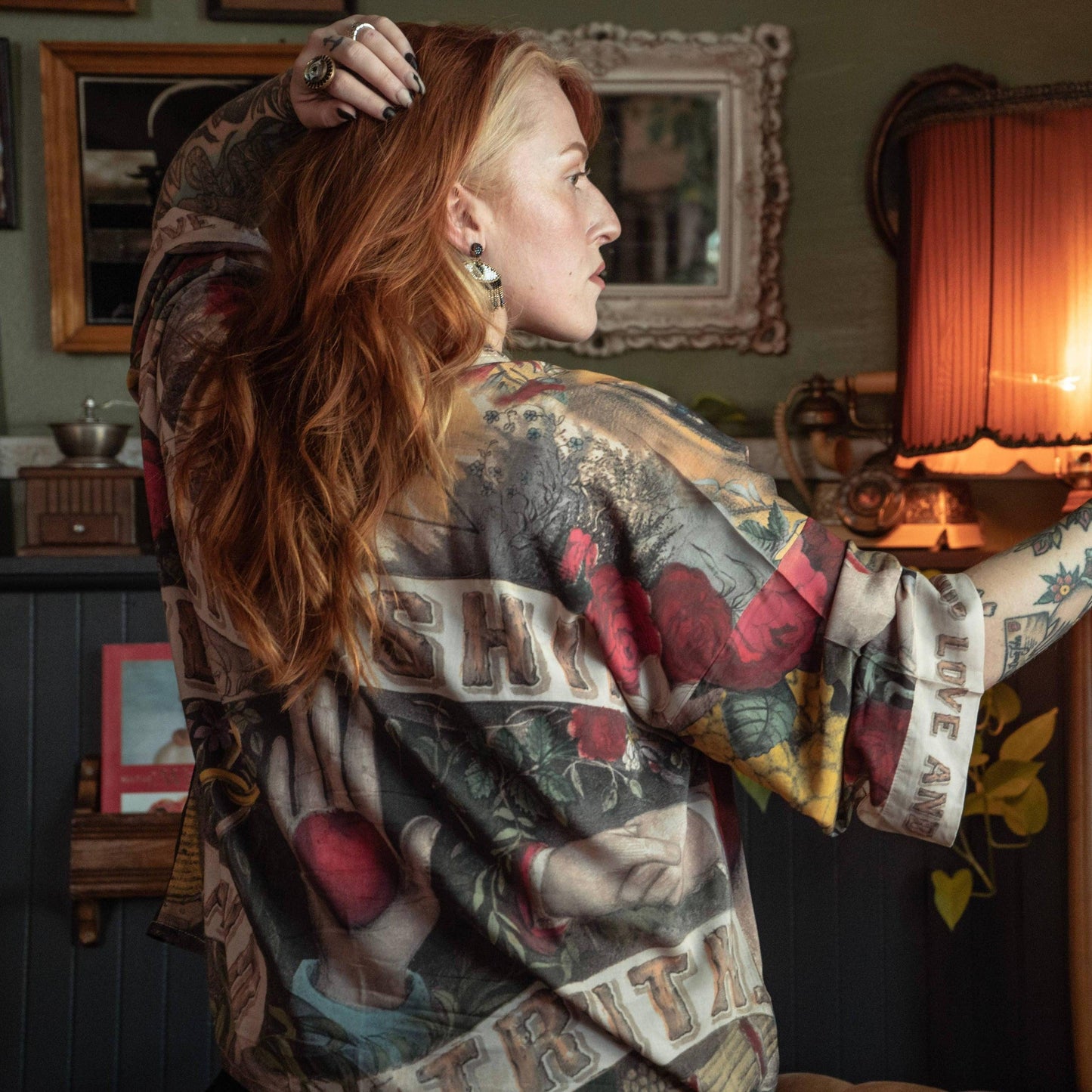 Woman wearing floral and tattoo-style heart-themed scarf with vintage decor background