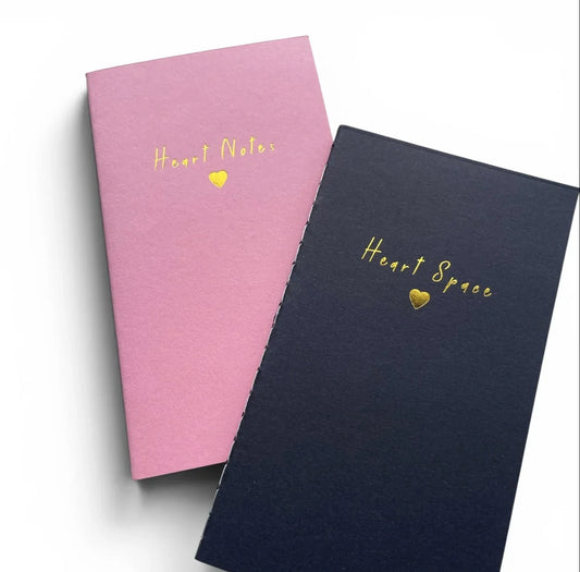 Pink and navy notebooks with gold 'Heart Notes' and 'Heart Space' text and heart symbols