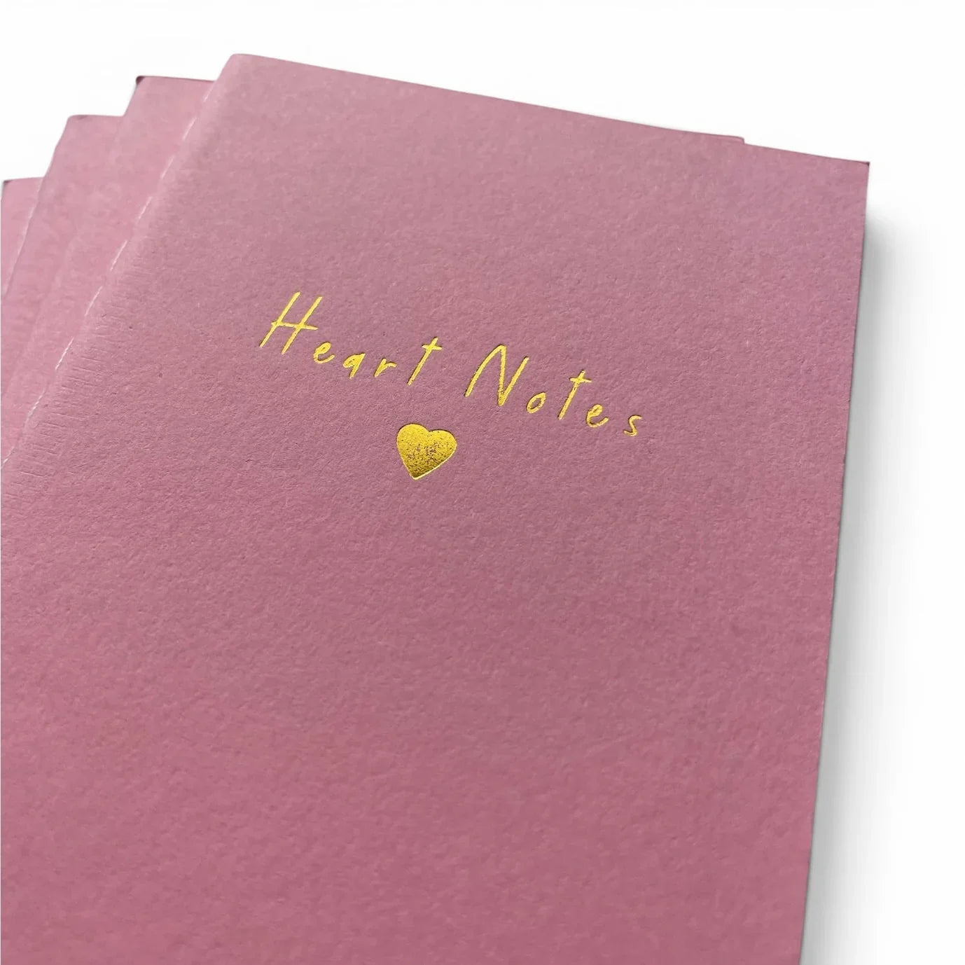 Pink notebook with gold 'Heart Notes' text and heart symbol, ideal for romantic gifts