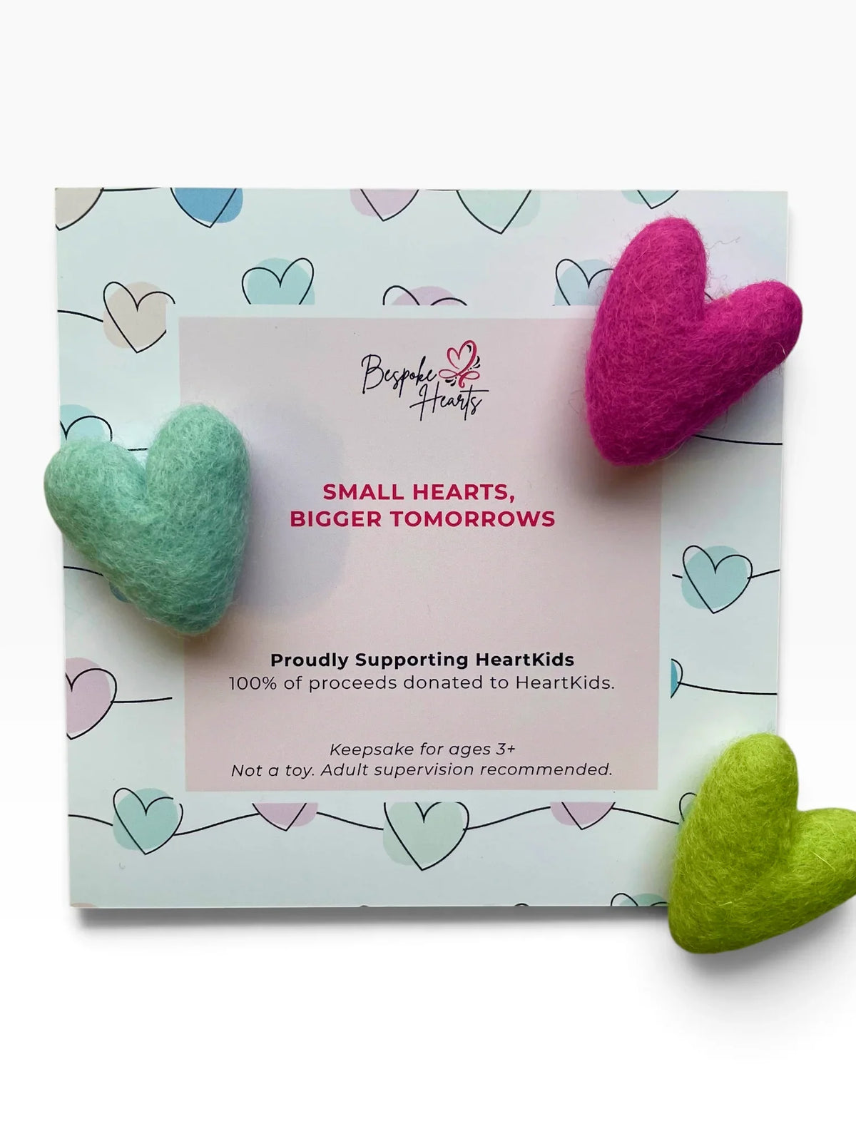 Bespoke Hearts Pocket Hugs in teal, pink, and green on a HeartKids donation card.