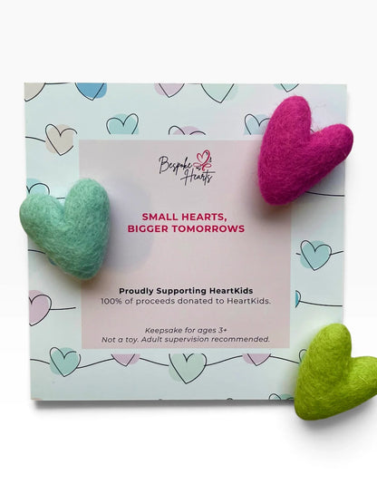 Bespoke Hearts Pocket Hugs in teal, pink, and green on a HeartKids donation card.