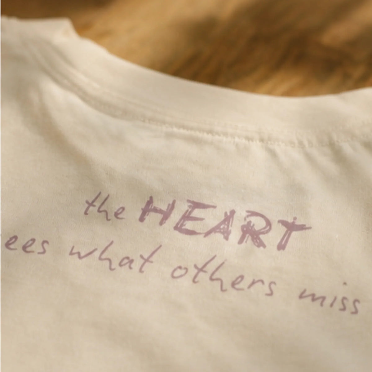 Back of tshirt neck with wording "The Heart sees what others Miss"