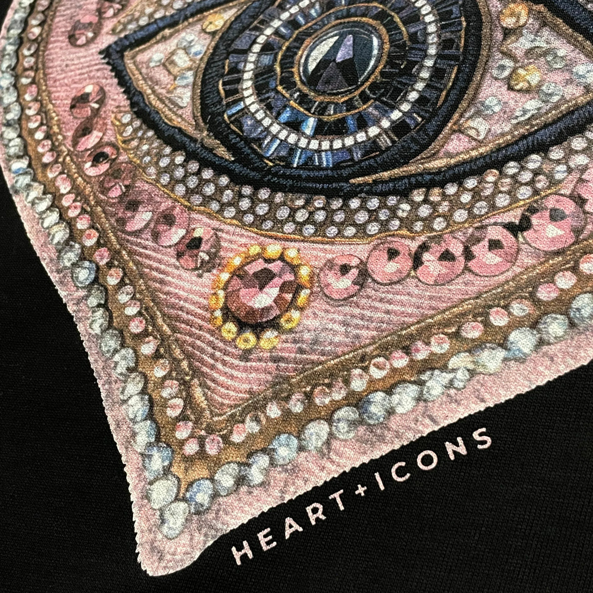 Detail of the Lover's Eye Tee by Bespoke Hearts featuring an ornate, jeweled heart design.