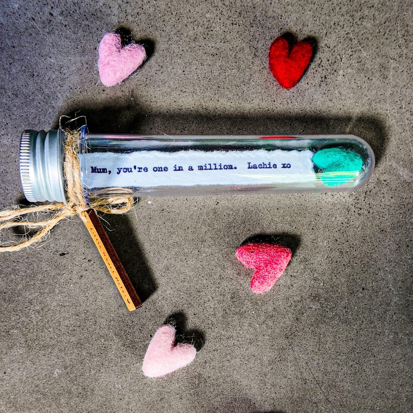 Personalised message in a gift tube with a felt heart.