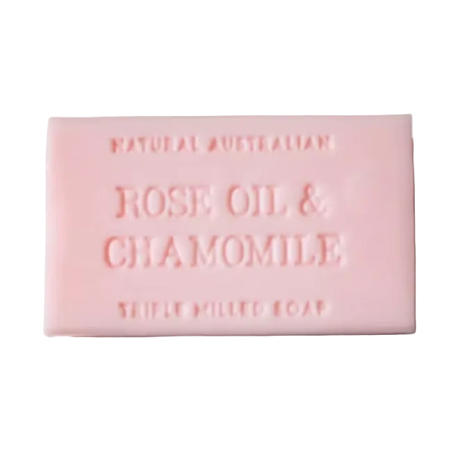 Pink bar of soap with 'Rose Oil & Chamomile' text on a light gray background