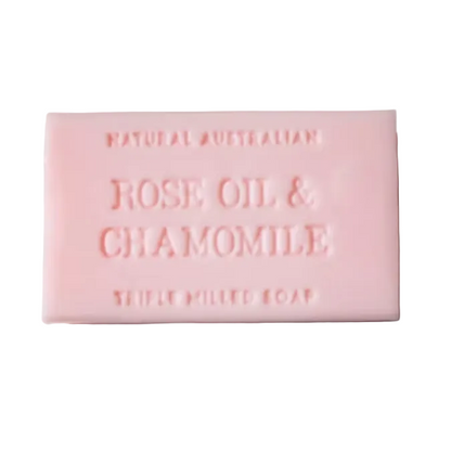 Pink bar of soap with 'Rose Oil & Chamomile' text on a light gray background
